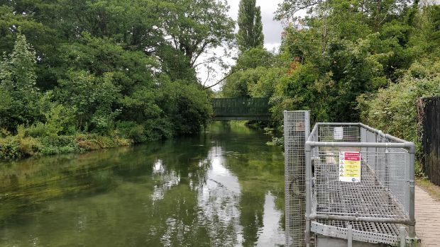 Metal fencing surrounding the inlet/outlet from the water treatment works into the Itchen Navigation